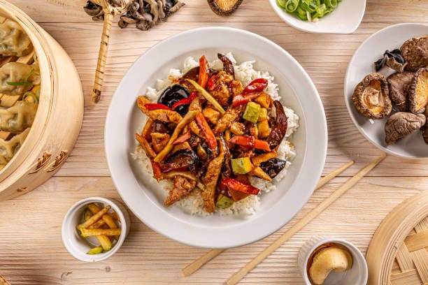 Turkey and vegetable stir fry served over rice, healthy Asian-inspired meal.