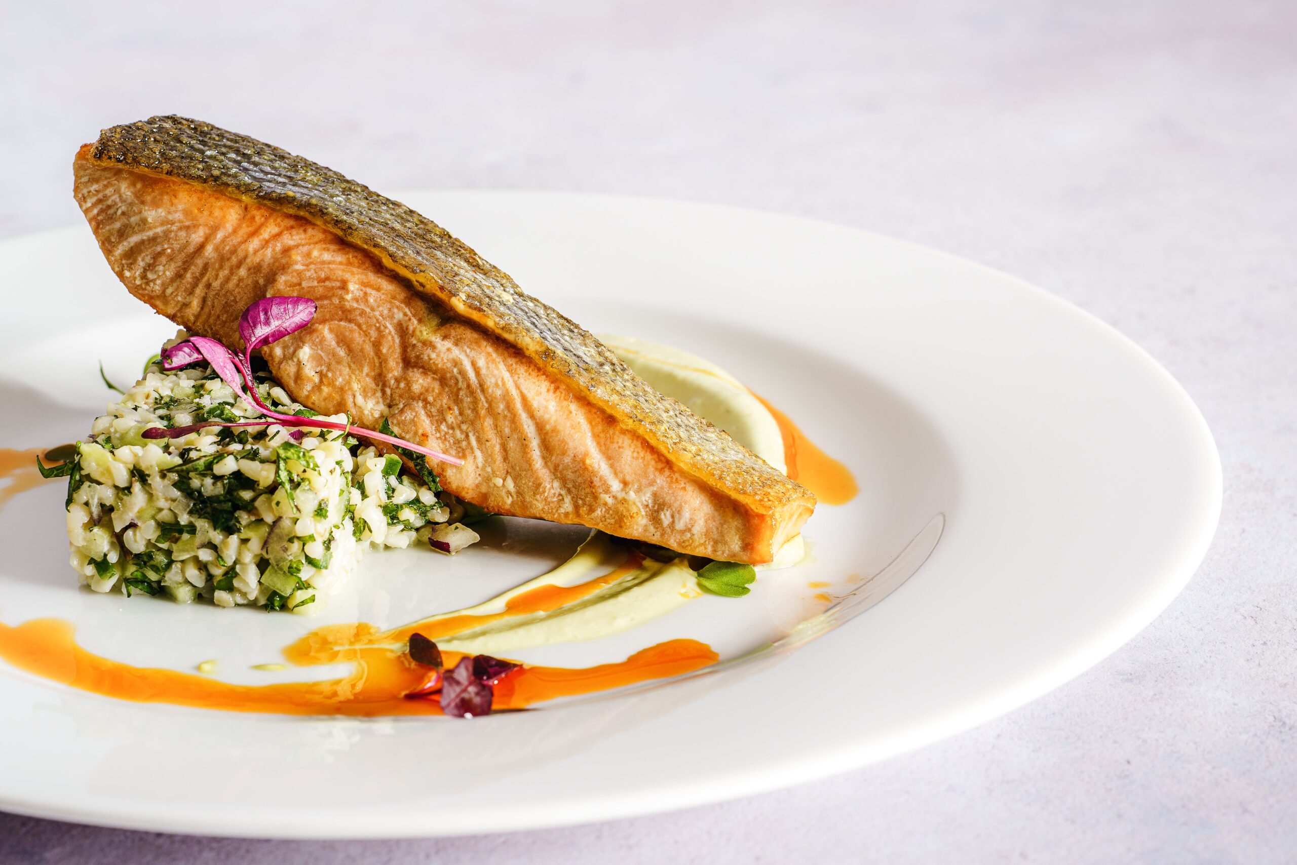 Healthy grilled lemon herb fish with fresh herbs and vegetables.