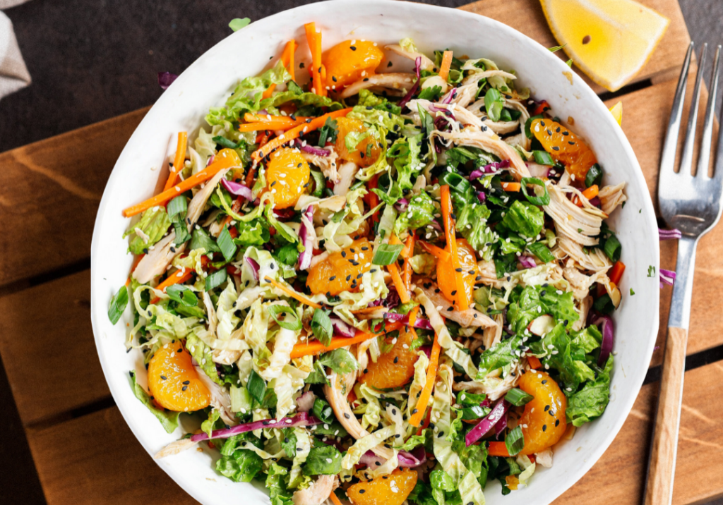 Vibrant Mandarin Ginger Salad with fresh greens, citrus segments, and crunchy vegetables. Perfect fo.