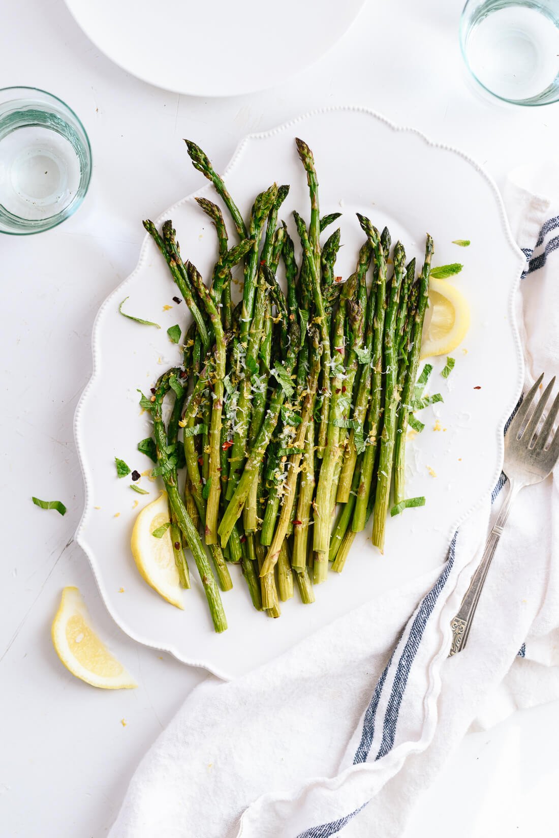 Healthy roasted asparagus seasoned with garlic and lemon zest. Perfect side dish for nutritious meal.