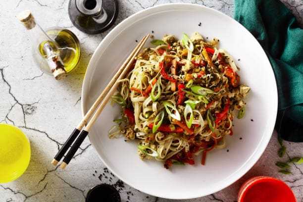 Delicious ginger-infused Pad Thai with zucchini noodles and vegetables.