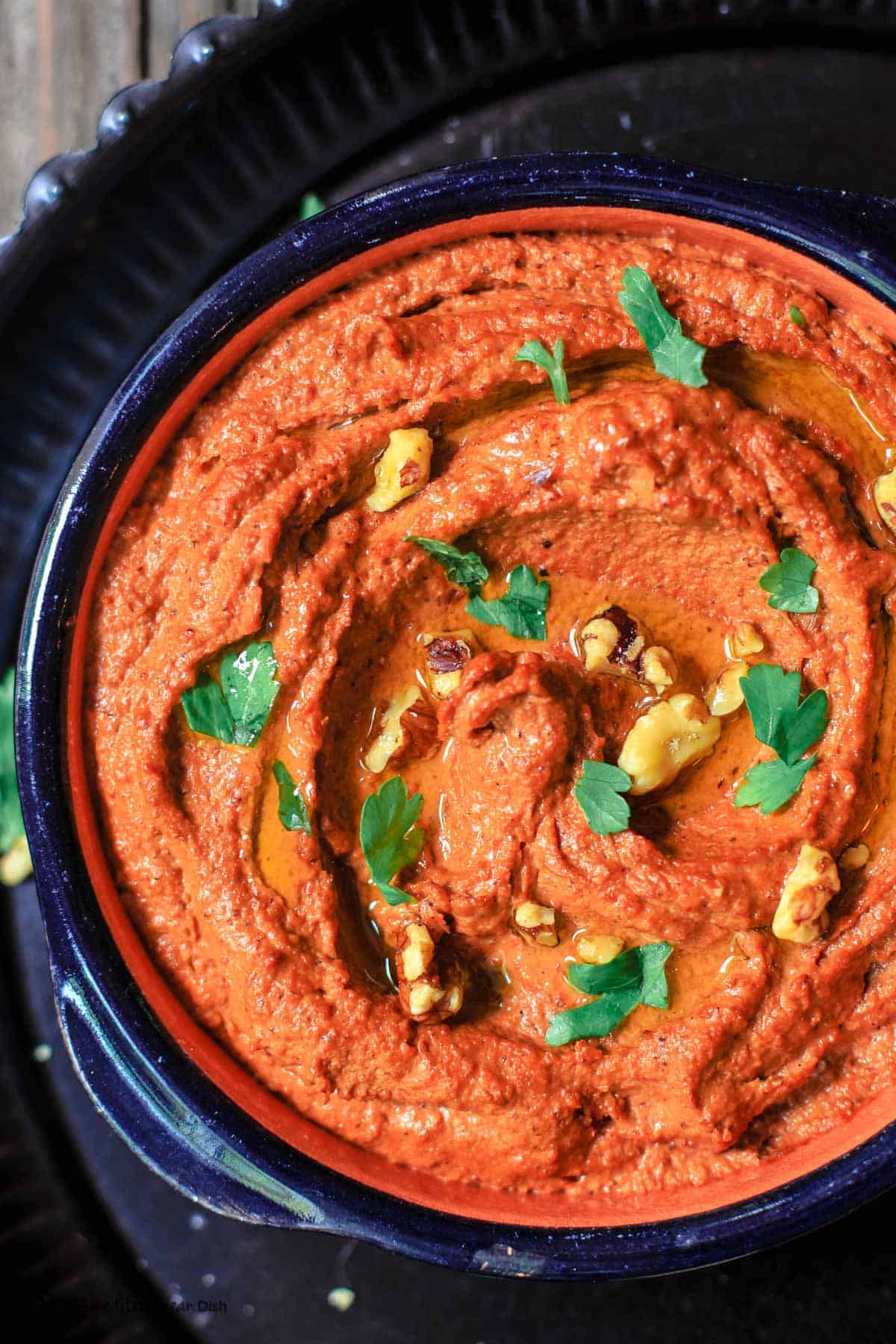 Delicious lentil dip garnished with herbs and nuts, perfect for healthy snacking.