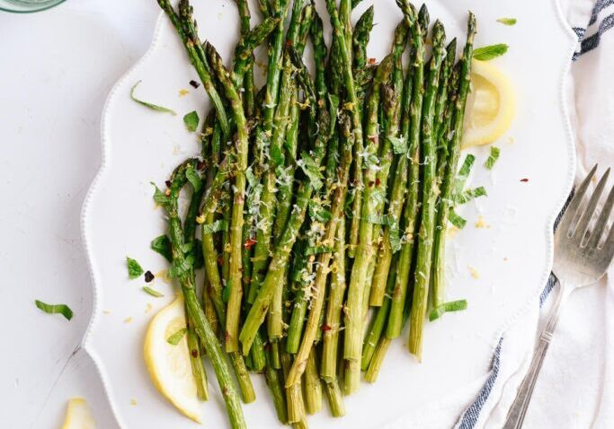 Healthy roasted asparagus seasoned with garlic and lemon zest. Perfect side dish for nutritious meal.