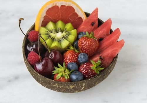 Colorful mixed fruit salad with strawberries, kiwi, watermelon, cherries, and blueberries in a choco.